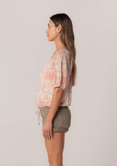 A charming short puff sleeve blouse in a natural and pink floral print. Floral print Cotton Relaxed fit Short puff sleeve Elastic cuff Scoop neckline Self-covered button front Adjustable drawstring waist with ties Lined Lightweight summer blouse Made with lightweight cotton, this spring blouse is perfect for any occasion. Designed in a pink floral print, with a scoop neckline and a relaxed fit. The short puff sleeves add a playful touch and make this blouse perfect for spring and summer. Model i Short Puff Sleeve Blouse, Womens Boho Tops, Spring Blouse, Spring Blouses, Short Puff Sleeve, Summer Blouse, Natural Coral, Pink Floral Print, Lightweight Shorts