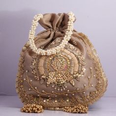 Beautiful Hand Embroidered Zardosi Work Golden Sequin Handbag Polti For Wedding Partys Giveaway Bridal Bag Shimmering Bag Dress Matching Bag Key Features: Embroidery art work This potli is good match with both Indian and western outfits and are superb for wedding and festive parties This would be best complement to your designer saree, lenhga or any other kind of dress This is the combination of traditional and modern embroidery work This is enough to keep your accessories and all needed essenti Traditional Gold Evening Bag With Pearl Embroidery, Embroidered Festival Pouch, Embroidered Pouch For Festivals, Festival Clutch With Gold Embroidery, Elegant Bags For Reception And Festivals, Elegant Bags For Festivals And Receptions, Bollywood Style Embroidered Evening Potli Bag, Bollywood Style Handwork Bags For Reception, Reception Potli Bag With Pearl Embroidery