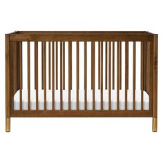 a wooden crib with white sheets on the bottom and sides, against a white background