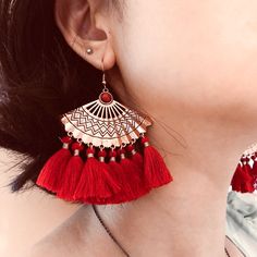 These unique bohemian fan tassel earrings feature red fan tassel on metal fan charm. Add these unique boho fan tassel dangle drop statement earrings to your everyday fashion earrings collection or as gift for your love one. Materials: mettal, cotton tasselFinish: rose gold color Jewelry Care: See more information about how to care for your jewelry here. Shipping Policy: Orders will be shipped within 1-3 business days. Economy shipping will take 7-14 days to arrive and standard shipping is 1- 4 d Metal Tassel Fringe Drop Earrings, Bohemian Metal Tassel Earrings For Party, Bohemian Metal Tassel Earrings With Fringe, Handmade Trendy Red Tassel Earrings, Trendy Red Tassel Earrings, Elegant Tassel Earrings For Festival, Trendy Dangle Tassel Earrings For Festivals, Trendy Tassel Dangle Earrings For Festival, Red Fringe Tassel Earrings For Summer