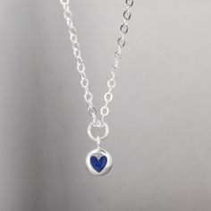 This stunning tiny heart necklace is inlay-ed with 100% natural crushed Crushed Lapis Lazuli Features & Measurements:✦ Sterling silver heart charm - 10.2mm x 7.4mm✦ Inlay is Lapis Lazuli ✦ Dainty sterling silver chain - Choose your length Lapis Lazuli is one of the most sought after stones in use since man's history began. Its deep, celestial blue remains the symbol of royalty and honor, gods and power, spirit and vision. It thought to be a universal symbol of wisdom and truth.Lapis Lazuli i Dainty Blue Birthstone Necklace For Everyday, Sapphire Sterling Silver Heart Pendant Necklace, Sapphire Heart Pendant Necklace In Sterling Silver, Blue Charm Necklaces With Round Pendant For Everyday, Sapphire Heart Pendant Necklace With Heart Charm, Everyday Blue Charm Necklace With Round Pendant, Blue Sterling Silver Jewelry With Heart Charm, Blue Birthstone Charm Necklace, Blue Sterling Silver Birthstone Necklace As Gift