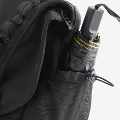 an electronic device is in the pocket of a backpack that's attached to it