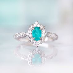 Gorgeous Vintage Inspired Neon Paraiba Tourmaline Ring Made of Solid Sterling Silver, Rhodium Plated (S925) Accented with Simulated Diamonds Center Stone: Paraiba Tourmaline Gemstone Creation: Lab-Created Stone Cut: Oval Color: Turquoise Gem size: 6.0 x 4.0 mm Carat Weight: 0.43 (approx.) Gemstone Origin: Brazil Can be made in solid gold and customized to a different gemstone. Please contact us if you have special requests. Handling time: 1-2 business days Free domestic shipping. Usually takes 2 Vintage Emerald Ring For Promise, Turquoise Emerald Ring For Anniversary, Elegant Silver Turquoise Ring With Birthstone, Elegant Silver Turquoise Birthstone Ring, Turquoise Gemstone Birthstone Ring For Wedding, Turquoise Birthstone Wedding Ring, Turquoise Emerald Ring For Wedding, Fine Jewelry Turquoise Birthstone Ring For Anniversary, Turquoise Birthstone Ring With Accent Stones For Anniversary