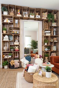 a living room filled with lots of wooden shelves and plants on top of each shelf