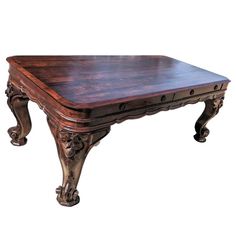 an old wooden table with ornate carvings on the top and bottom, against a white background