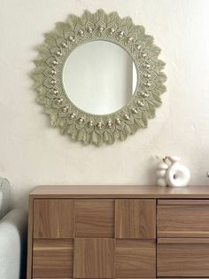 a mirror on the wall above a dresser