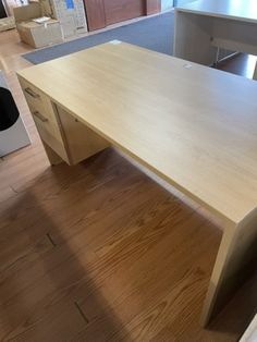 a wooden desk sitting on top of a hard wood floor