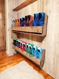 there are many pairs of shoes that are on the shelves in this room, and one pair is multicolored