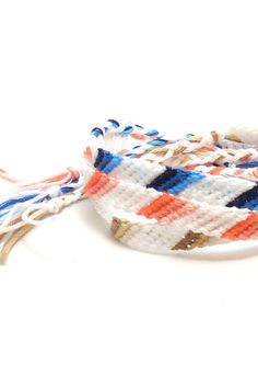 the multicolored bracelet is attached to a white cord