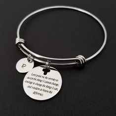 "Serenity Prayer Bracelet Personalized Initial Bangle Bracelet! A round charm printed with Serenity Prayer beginning with \"Lord grant me the serenity\" on a stainless steel expandable bangle bracelet makes the perfect gift for you or a loved one. God, grant me the serenity to accept the things I cannot change, Courage to change the things I can, And wisdom to know the difference. The religious bracelet charm is made from stainless steel and measures 24 mm by 24 mm. The bible verse bracelet is h Inspirational Jewelry For Friendship, Inspirational Friendship Bracelet Jewelry, Adjustable Round Bracelet As Best Friend Gift, Inspirational Bangle Jewelry For Best Friend Gift, Inspirational Bangle For Best Friend Gift, Spiritual Round Stainless Steel Bracelets, Adjustable Stainless Steel Charm Bracelet For Friendship, Adjustable Stainless Steel Friendship Charm Bracelet, Meaningful Adjustable Bangle Bracelet