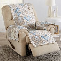 the recliner is covered with a blue and white quilt