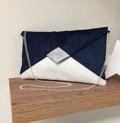 Navy blue and white wedding clutch with silvery sequins, small envelope-shaped handbag, customizable shoulder bag, very trendy to accessorize your outfit, a wedding, bridesmaids or a ceremony. The evening clutch will easily contain your indispensable phone, make-up, keys, glasses, papers... It is made of suedette with a very velvety touch, suede effect.  The tip of the flap is covered with silver glitter fabric.  2 options are possible: WITH or WITHOUT chain, removable shoulder strap, you choose Clutch Bag Wedding, Clutches For Women, Wedding Clutch, Blue Handbags, Glitter Fabric