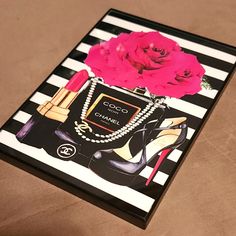 a black and white striped book with a pink rose on it