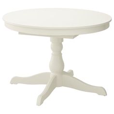 a white round table with four legs