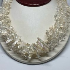 a white necklace with clear glass beads