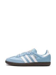 Find ADIDAS Samba Team Argentina Sneakers on Editorialist. light blue/white signature 3-Stripes logo logo print to the side round toe front lace-up fastening logo-print tongue contrasting heel counter gum-rubber sole These styles are supplied by a premium sneaker marketplace. Stocking only the most sought-after footwear, they source and curate some of the most hard to find sneakers from around the world. Light Blue Adidas Shoes, Blue Low-top Sneakers With Three Stripes, Light Blue Sneakers For Sports With Rubber Sole, Low-top Sneakers With Three Stripes And White Sole, Sporty Light Blue Sneakers With Contrast Sole, Blue Sneakers With Contrast Sole In Athleisure Style, Blue Adidas Sneakers With Vulcanized Sole, Adidas Blue Sneakers With Vulcanized Sole, Blue Skate Shoes With Three Stripes And Round Toe