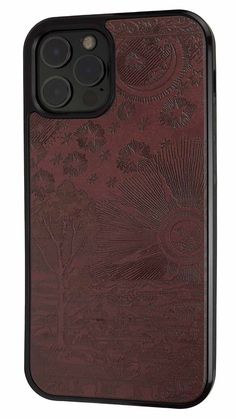 the back of an iphone 11 case with a red leather cover and intricate designs on it