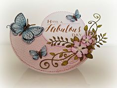 a pink card with butterflies on it and a white circle that says have a fabulous day