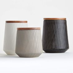 three different types of vases on a white surface