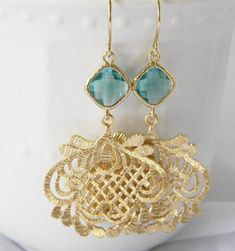 Gorgeous ethnic filigree pendants and sea green glass diamonds hang from 14 karat gold plated earwires. Earrings hang approximately 2 1/2 inches from the ear and come with plastic ear nut protectors. All items are individually gift boxed. Please visit my shop here: https://www.etsy.com/shop/Greenperidot Bridesmaid Earrings Gift, Large Gold Earrings, Green Dangle Earrings, Bridesmaid Gifts Earrings, Flower Girl Jewelry, Gold Filigree Earrings, Bride Earrings, Earrings Bridesmaid, Filigree Pendant