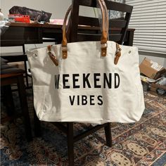 White Canvas Overnight Bag With Black Writing-Weekend Vibes! This Bag Is Huge And Can Carry Everything You Need For The Weekend Or For Just A Day At The Beach. Zippered Pocket On The Back, A Pocket On Each End, 3 Slip Pockets Inside, A Zipper Pocket Inside. Canvas Weekender Bag, Wall Decor Men, Lime Green Shorts, Vera Bradley Purses, Brown Leather Shoulder Bag, Chalk White, Black Tote, Purses Michael Kors, Large Canvas