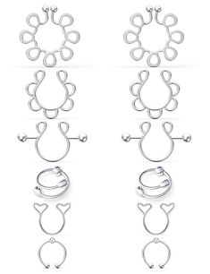 four pairs of silver earrings with hearts and circles on them, all in different shapes