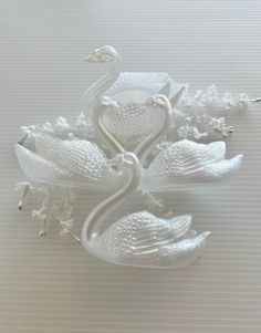 two white swan figurines sitting on top of each other