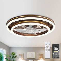 a living room with a ceiling fan and remote control