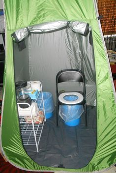 a green tent with two blue buckets in it