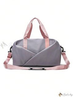 a gray and pink duffel bag sitting on top of a white surface