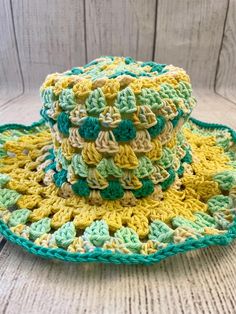 a crocheted hat sitting on top of a wooden table