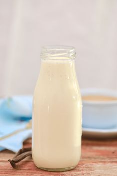 a bottle of milk sitting on top of a wooden table