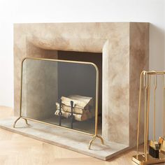 a fireplace with a mirror on the mantle next to it and some gold items in front of it