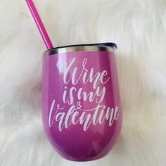 a wine glass with the words wine is my valentine written on it and a pink straw sticking out of it