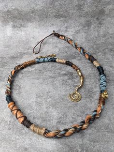 the necklace is made with multicolored beads and gold clasps on an adjustable cord