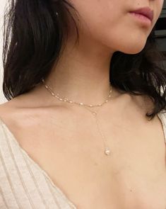 "A lariat choker with a single drop of designer grade, freshwater pearl. I love the touch of roped ring on this minimal piece. Every component is so delicate and elegant on the decolletage.  Around neck length is 15\", drop length is  2 5/8\". Chain: solid sterling silver. Jump Rings: sterling silver plated. Clasp: platinum plated stainless steel. Pearl: genuine fresh water pearl *please note that size and shape may vary due to the nature of genuine pearls* ~Thank you for visiting my humble shop! All items are handmade with care and love. Please feel free to message me with any questions or comments! I hope you like my pieces~ ~all items are hand made and unique, therefore the components may have some variance.  Each piece will be made with utmost care, but they are delicate so please be c Pearl Charm Necklace With Clavicle Chain, Pearl Clavicle Chain Charm Necklaces, Adjustable Dangle Pearl Chain Lariat Necklace, Adjustable Dangle Lariat Necklace With Pearl Chain, Pearl Charm Lariat Jewelry, Adjustable Lariat Necklace With Pearl Charm, Adjustable Dangle Lariat Necklace With Pearl Pendant, Adjustable Lariat Necklace With Pearl Pendant, White Adjustable Lariat Necklace With Pearl Charm