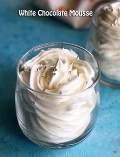 white chocolate mousse in small glass dishes on a blue surface with the words, white chocolate mousse