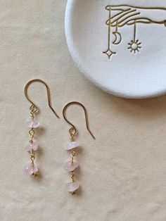 "These rose quartz gold filled earrings drop about 3cm from the bottom of the ear-wire and the width of the stones measure about 7mm each.   All pieces are carefully handmade by me at home, and while I try my best to make pairs that match, there may be some subtle differences in the wire-work and natural stone shapes. R O S E  Q U A R T Z  Properties: Purifying, restores trust and harmony, promotes unconditional love and feelings of peace Zodiac: Taurus, Libra Scorpio As these are natural gemsto Handmade Dainty Long Drop Linear Earrings, Dainty Natural Stone Dangle Earrings, Dainty Handmade Linear Long Drop Earrings, Handmade Dainty Crystal Drop Earrings, Handmade Dainty Dangle Linear Earrings, Dainty Dangle Earrings With Natural Stones, Nickel-free Rose Quartz Dangle Earrings, Wire Wrapped Long Drop Linear Earrings For Gifts, Handmade Rose Quartz Dangle Earrings