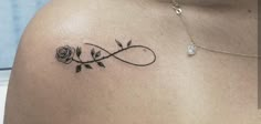 a woman with a tattoo on her shoulder that has a rose and an infinite sign