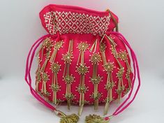 golden tubelight & peal beaded embellish fuchsia handbag for woman | beautiful indian wedding potli purse for woman | fabric drawstring bagPackage Contents: 1Size: 10" x 8"Designed with the heart, this beautiful Potli or batawa bag are eye catchy and made of premium material.Key Features:Embroidery art work. (zardosi work).This potli is good match with both Indian and western outfits and are superb for wedding and festive parties.This would be best complement to your designer saree, lenhga o Elegant Pink Potli Bag For Festivals, Gold Pouch With Latkans For Festivals, Traditional Pink Pouch For Festive Occasions, Traditional Pink Pouch For Festive Season, Festive Pink Potli Bag For Party, Gold Festive Clutch For Festivals, Pink Pouch Bag For Festive Occasions, Pink Handwork Potli Bag For Party, Pink Handwork Potli Bag For Diwali