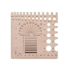 a wooden ruler with numbers and lines on the front, and an arrow in the middle