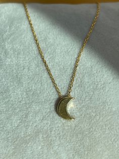 925 Sterling Silver Gold Crescent Moon Necklace Elevate your style with this delicate and elegant 925 sterling silver necklace, beautifully plated in gold for a luxurious touch. Featuring a finely crafted crescent moon pendant, this piece embodies the beauty of simplicity with its minimalist design, making it perfect for everyday wear or layering with other necklaces. The dainty chain and sleek crescent moon motif create a sense of understated elegance, ideal for those who appreciate subtle yet meaningful accessories. Whether you're dressing up for a special occasion or adding a touch of elegance to your daily outfit, this necklace offers versatile wearability. Product Features: Material: 925 Sterling Silver Plating: Gold Design: Minimalist crescent moon pendant Chain: Thin and delicate fo Silver Sun And Moon Design Gold-plated Necklace, Gold Necklaces With Sun And Moon Half Moon Design, Gold Necklaces With Sun And Moon Design, Gold Crescent Celestial Necklace, Elegant Yellow Gold Charm Necklace With Moon Phase, Gold Sterling Silver Necklace With Sun And Moon Design, Elegant Yellow Gold Moon Phase Charm Necklace, Celestial Crescent Gold Necklace, Gold Crescent Charm Necklace With Clavicle Chain