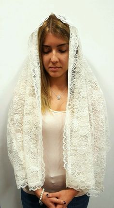 Wearing chapel veils during Mass and when praying had always been a traditional practice for centuries. Even though it is not mandatory, many women still choose to wear veils or other headcoverings as a sign of reverence , humility and modesty before God. This beautiful rectangular chapel veil is made entirely of italian lace and presents a rose embroidery pattern and scalloped edges. It is available in three different colors: white, ivory and black. Perfect for women of all ages, it is long eno Traditional Lace Shawl With Lace Trim, Lace Work Dupatta For Wedding, Wedding Lace Shawl Dupatta, White Bohemian Lace Dupatta, Bohemian White Lace Dupatta, Traditional White Veil, Traditional Lace Dupatta Shawl, Wedding Lace Dupatta Shawl, White Shawl For Traditional Ceremonies