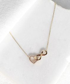 14K Gold Heart and Infinity Symbol Necklace A symbol of infinite love, this elegant necklace showcases the symbols of love and eternity entwined with each other. The heart motif perfectly complements the infinity symbol for a truly romantic look. This unique necklace is perfect for everyday wear as it is made of solid gold and won't tarnish. It is a wonderful gift for a special person. Features: * This necklace is made of patented 14K solid gold. * Length: 42 cm Packaging: You will get your jewe Sterling Silver Infinity Heart Necklace For Anniversary, Infinity Diamond Necklace In Yellow Gold, Yellow Gold Infinity Diamond Necklace, Gold Infinity Necklace For Anniversary Gift, Gold Infinity Necklace For Anniversary, Diamond Infinity Necklace For Anniversary, Elegant Necklace With Adjustable Chain For Anniversary Gift, Infinity Necklace With Diamond Accents In Cubic Zirconia, Cubic Zirconia Infinity Necklace With Diamond Accents