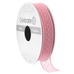 a spool of pink glitter ribbon on a white background with the words celebrate printed on it