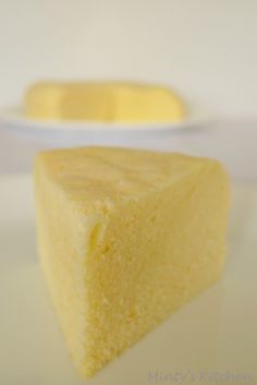 a piece of yellow cake sitting on top of a white plate