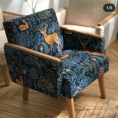 an upholstered chair with deer and plants on it