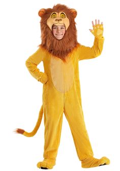 a young boy in a lion costume standing with his hands up and smiling at the camera