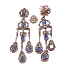 This is part of Chairish’s Fine Jewelry assortment.  Vintage 9.71 CTW sapphire & diamond girandole dangle earrings. These Victorian style vintage earrings are crafted in 18 karat yellow gold topped with silver. They feature 9.71 CTW of oval sapphires that are very well matched, eye clean, and have slight color zoning. These earrings are accented with 246 full cut diamonds at 2.00 carats total weight. The diamonds have VS1-2 clarity, with a few SI2, and have K-L-M light brown color. These earring Victorian Blue Jewelry With Diamond Accents, Formal Rose Cut Diamond Chandelier Earrings, Elegant Yellow Gold Chandelier Earrings With 17 Jewels, Formal Chandelier Earrings With Rose Cut Diamonds, Fine Jewelry Chandelier Earrings With 17 Jewels, Fine Jewelry Chandelier Drop Earrings, Elegant Rose Cut Diamond Chandelier Dangle Earrings, Ornate Hallmarked Dangle Chandelier Earrings, Ornate Hallmarked Chandelier Dangle Earrings