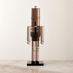 a metal robot sculpture sitting on top of a table